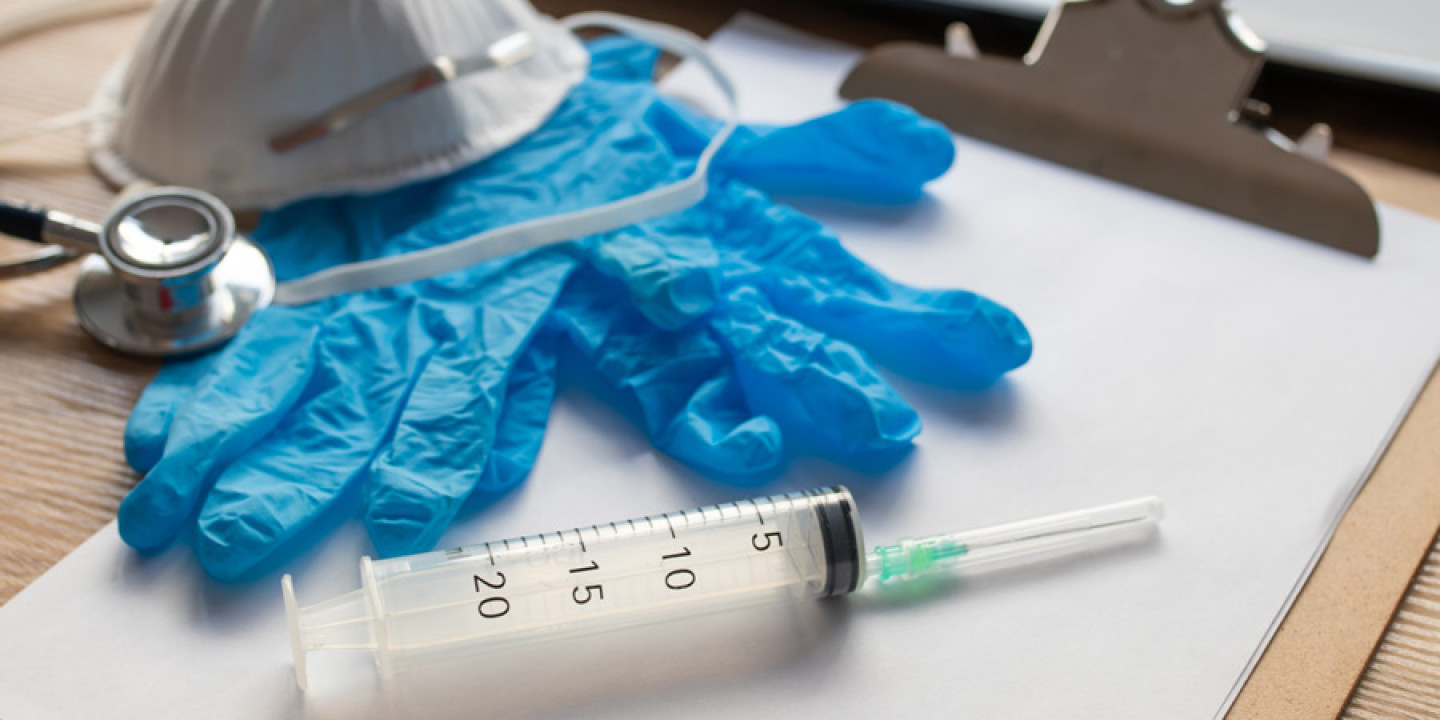 syringe with gloves and medical protection mask